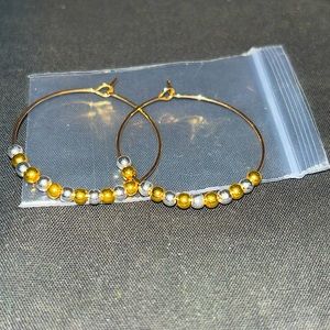 Pair of small, gold and silver hoop earrings
